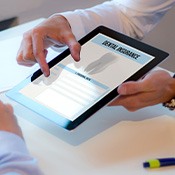 Patient reviewing dental insurance information on tablet