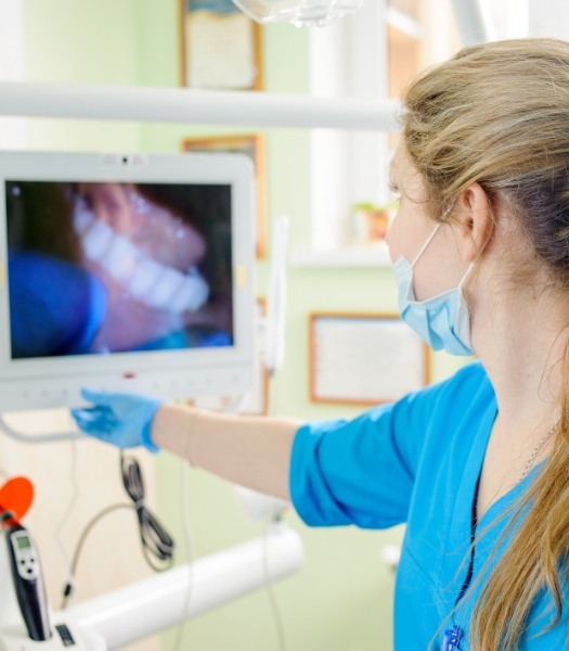Dentist examining intraoral camera images