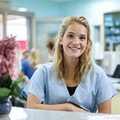 Patient and dental team member interacting at front desk