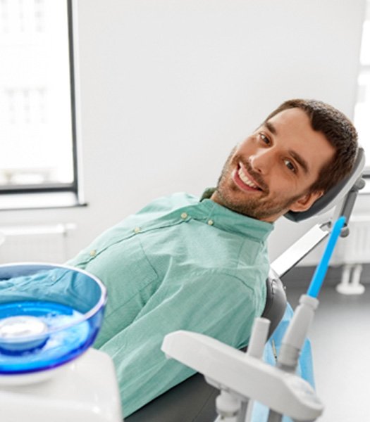 Male dental patient smiling in a dentist’s office