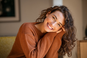 Young woman leaning forward and smiling